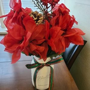 Christmas themed mason jar with fake poinsettias